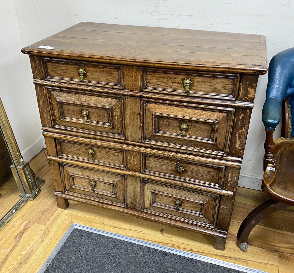 A late 17th century oak two part chest of two short and three long drawers, with geometric moulded panelled front, width 102cms, depth 56cms, height 95cms.